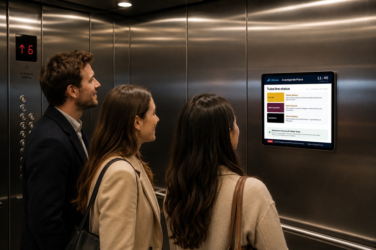 Residents in a lift looking at a wall-mounted LiftLine display showing live Tube line status